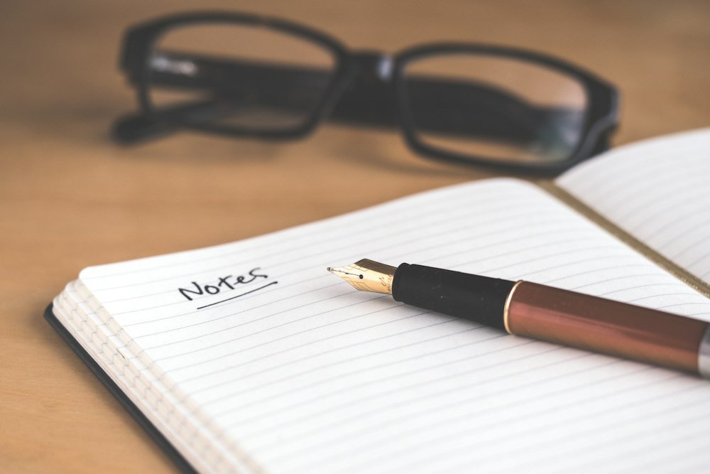 A handwritten journal resting on a rustic wooden table with morning light and warm coffee