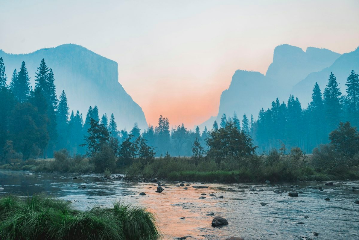 Mountain lake during early morning mist and quiet sunrise